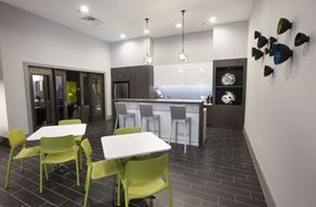 Dallas apartment for rent - A modern kitchen with a dining table and chairs.