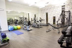 Dallas apartment for rent - A gym with a variety of equipment including weights and exercise balls.