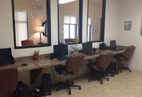 Lake Wales apartment for rent - A room with a long table and chairs with laptops on it.