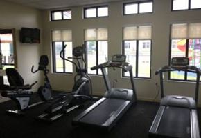 Lake Wales apartment for rent - A gym with treadmills, elliptical machines, and a television.