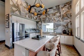 Fort Worth apartment for rent - A kitchen with a marble backsplash and a large island.