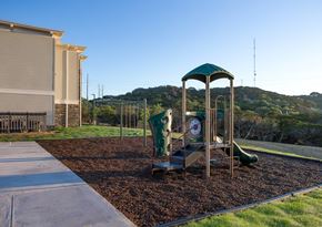 Kerrville apartment for rent - A playground with a green and white slide and a green canopy.