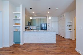 Austin apartment for rent - A kitchen with a white counter and wooden floors.