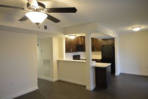 Denton apartment for rent - A kitchen with a black refrigerator and a white island.