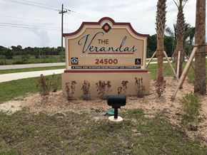 Punta Gorda apartment for rent - A sign for The Verdanas Senior Apartment Homes sits in front of a mailbox.