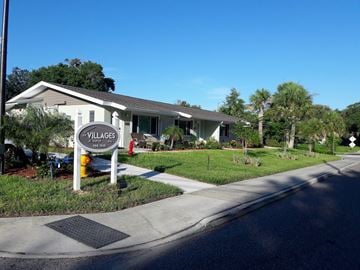 Tarpon Springs apartment for rent - A sign for Villages at Peterson Park is on the corner of a street.