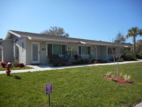 Tarpon Springs apartment for rent - A house with a purple sign in front of it.