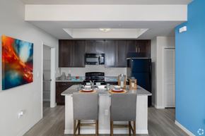 Fort Myers apartment for rent - A modern kitchen with a dining table set for two.