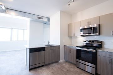 Longview apartment for rent - A modern kitchen with a stainless steel oven and microwave.