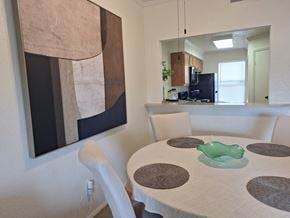 Abilene apartment for rent - A modern dining room with a large abstract painting on the wall.