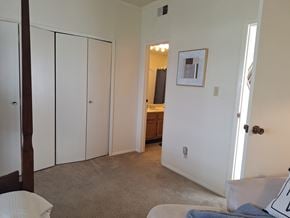 Abilene apartment for rent - A bedroom with a white bed and a picture on the wall.