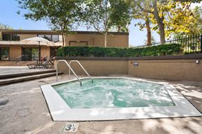 Westminster apartment for rent - a hot tub in a backyard with a house in the background