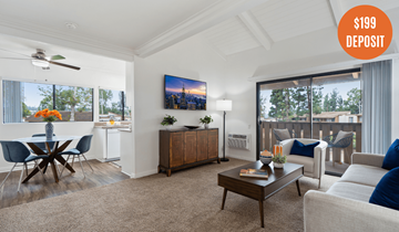 Laguna Hills apartment for rent - A living room with a dining table and a flat screen TV on the wall.