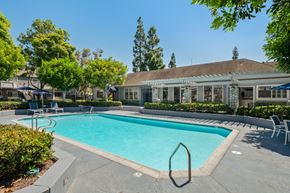 Costa Mesa apartment for rent - a swimming pool with a building in the background