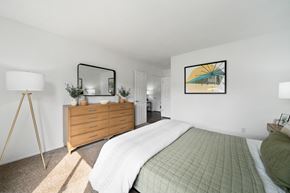 Westminster apartment for rent - a bedroom with a bed and a dresser and a mirror