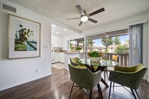 Anaheim apartment for rent - a dining area with a table and chairs and a ceiling fan