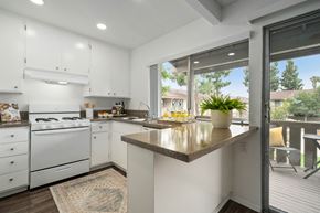 Anaheim apartment for rent - a kitchen with white cabinets and a large window