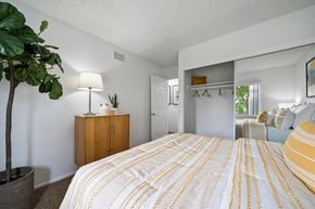 Anaheim apartment for rent - a bedroom with a yellow and white bedspread