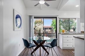 Anaheim apartment for rent - a dining room with a glass table and chairs and a window