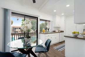 Anaheim apartment for rent - a kitchen and dining area with a glass table and chairs
