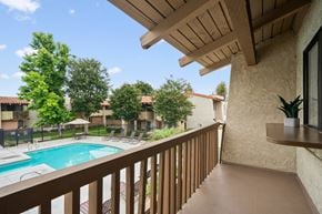 Anaheim apartment for rent - a view of a swimming pool from the balcony of a resort condo