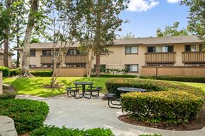 Westminster apartment for rent - a patio with tables in front of an apartment building