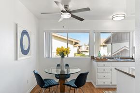 Tustin apartment for rent - a dining room with a table and chairs and a ceiling fan