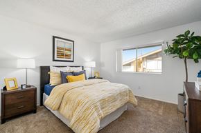 Tustin apartment for rent - a bedroom with a bed and a window