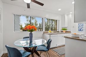 Laguna Hills apartment for rent - an open kitchen and dining room with a glass table and chairs