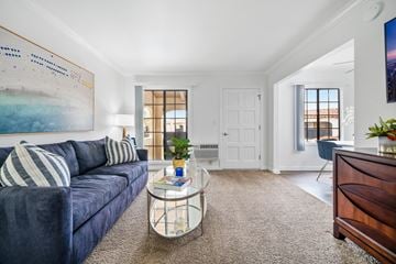 Tustin apartment for rent - a living room with a blue couch and a glass coffee table
