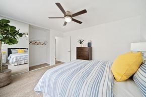 Tustin apartment for rent - a bedroom with a bed and a ceiling fan