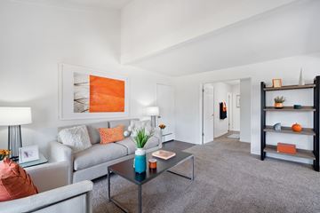 Fullerton apartment for rent - A living room with a grey couch, a coffee table, and a painting on the wall.