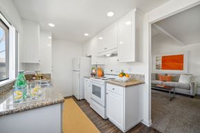 Fullerton apartment for rent - A kitchen with white cabinets and a granite countertop.
