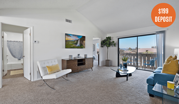 Rowland Heights apartment for rent - A living room with a white chair, a blue couch, and a painting on the wall.