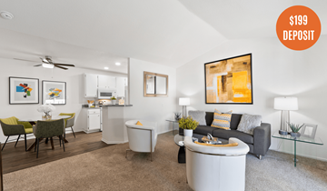 Costa Mesa apartment for rent - A living room with a grey sofa, a white coffee table, and a painting on the wall.
