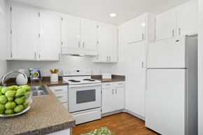 Fullerton apartment for rent - a white kitchen with white appliances and white cabinets