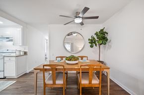 Fullerton apartment for rent - a dining room with a table and chairs and a ceiling fan