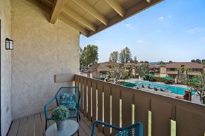 Rowland Heights apartment for rent - a balcony with two chairs and a view of a swimming pool