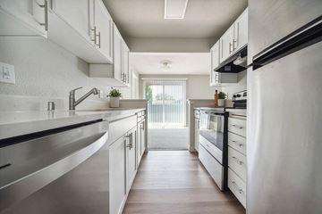 Fife apartment for rent - A modern kitchen with white cabinets and stainless steel appliances.