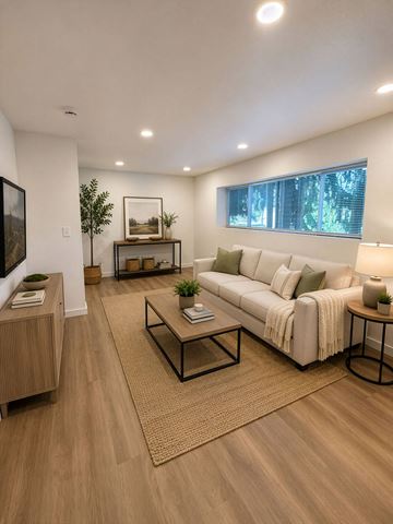 Burien apartment for rent - A modern living room with a white sofa and a wooden floor.