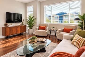 Snoqualmie townhouse for rent - A living room with a glass coffee table and a flat screen TV on the wall.