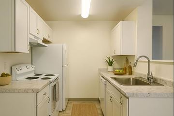 Tacoma apartment for rent - A kitchen with white appliances and cabinets.