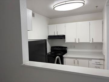 Tacoma apartment for rent - A black dishwasher is in a white kitchen.