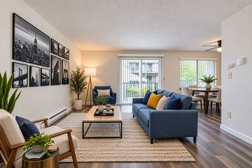 Burien apartment for rent - A living room with a blue couch and a coffee table.
