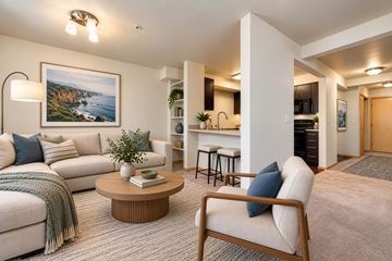 Seattle apartment for rent - A living room with a sofa, a chair, a coffee table, and a painting on the wall.