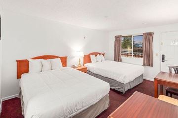 Renton apartment for rent - A bedroom with two beds and a table.