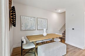 Kissimmee townhouse for rent - A dining room with a wooden table and chairs.