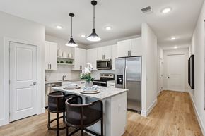 Kissimmee townhouse for rent - A modern kitchen with a dining table set for two.