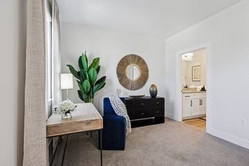 Kissimmee townhouse for rent - A living room with a blue chair and a wooden table.