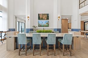 Orlando apartment for rent - A community kitchen with a long table and chairs.